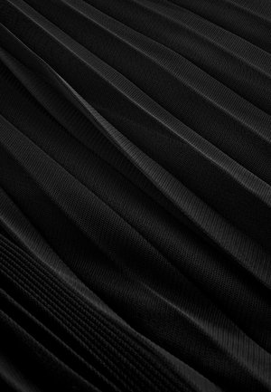 Black pleated fabric featuring a textured pattern with alternating smooth and ribbed sections, showcasing depth and dimensionality.