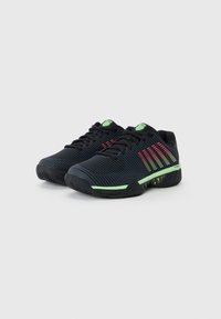 Black athletic shoes with textured upper, green accents, and red stripes. Features a rugged sole for traction and a rubber toe guard.