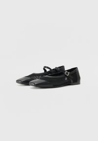 Black ballet flats with a mesh upper and solid toe cap. Features a small strap with a buckle for secure fit. Flat sole and minimalistic design.