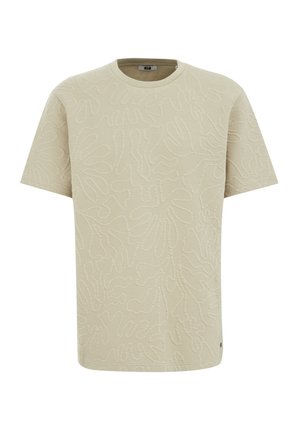 Ljust beige kortärmad t-shirt med en texturerad blommönster, rund halsringning och en liten logodetalj nära fållen.