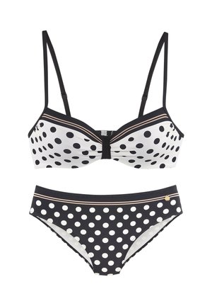 Two-piece swimsuit with black and white polka dots, black straps, and a small gold accent on the bottom piece.