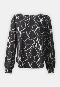 Blouse noire à manches longues avec un motif floral abstrait blanc, col rond, fermeture éclair à l'arrière et poignets élastiques.