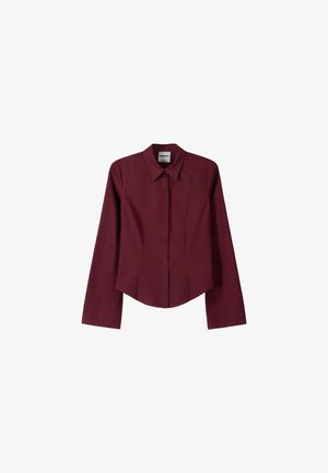 Burgundy long-sleeve button-up shirt with a pointed collar, tailored fit, and vertical seam detailing, made from a smooth fabric.