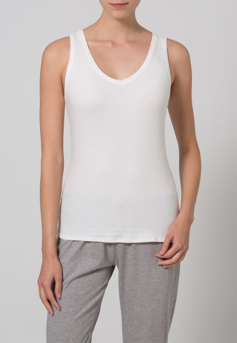 White sleeveless V-neck tank top made of smooth fabric, paired with light gray loose-fitting pants. Simple design with no visible patterns.
