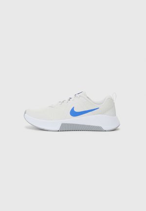 White athletic shoes with a breathable mesh upper, blue Nike swoosh, and textured gray rubber sole. Features flat laces and a pull tab.