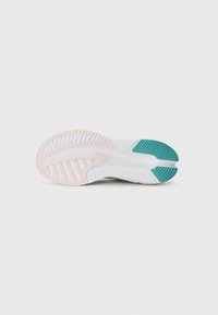 White and light pink athletic shoe sole featuring a textured surface and multiple grooves, with teal accents on the heel area.