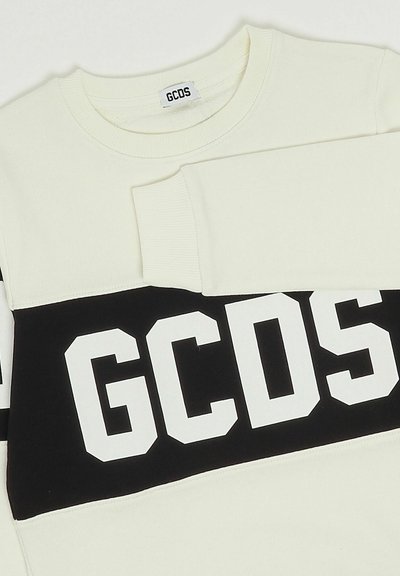 Cremefarbenes Sweatshirt mit einem schwarzen horizontalen Streifen und großen weißen "GCDS"-Buchstaben. Weicher Stoff mit gerippten Bündchen und Kragen.
