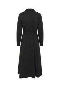 Black trench coat with long sleeves, a collar, and a belted waist. Features a flowing skirt, textured fabric, and buttoned cuffs.