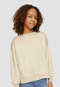 Jasno beżowy sweatshirt z długimi rękawami, luźny krój, okrągły dekolt i ściągacze. Miękka tekstura i minimalistyczny design.
