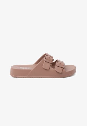 Pink plastic slide sandal with two adjustable buckles, textured upper surface, and a flat rubber sole featuring a zigzag pattern.