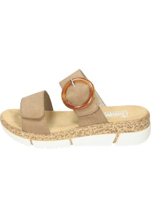 Sandale à glissière en daim marron avec une semelle texturée en liège, une semelle intermédiaire blanche et un grand accent circulaire de couleur ambre sur la bride.