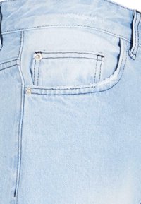 Light blue denim jeans featuring a back pocket with silver hardware accents, frayed edge detail, and tonal stitching.