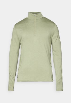 Lichtgroene, lange mouwen pullover met een halve rits kraag, textuurstof en zijsplitten aan de onderrand voor gemakkelijk bewegen.