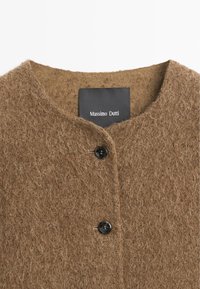 Brown textured wool cardigan with round neckline and two black buttons, showing Massimo Dutti brand label inside collar.