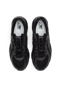 Black mesh sneakers with a padded tongue, lace-up closure, and silver accents. Features New Balance logo on the insole.