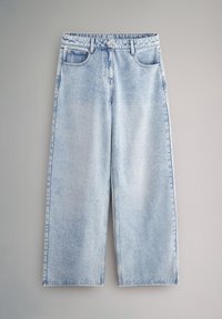 Vaqueros de pernera ancha de color azul claro con bolsillos delanteros, trabillas para cinturón y cierre de botón sobre un fondo gris liso.