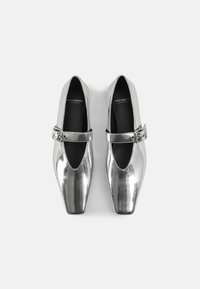 Silver metallic shoes with a square toe design and a side buckle strap. Smooth texture with a glossy finish. Black inner lining.