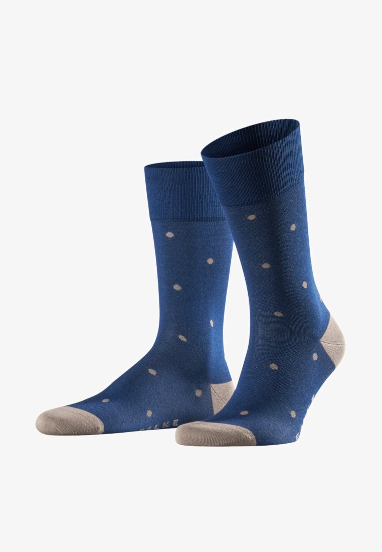 Blaue Socken mit einem gerippten Bündchen, die ein beigen Punktmuster sowie eine beigen Zehen- und Fersenpartie aufweisen. Hergestellt aus einem glatten, dehnbaren Material.