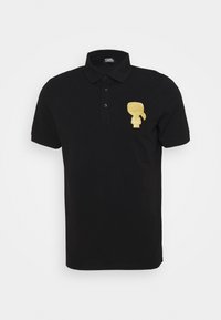 Černé polo triko z bavlny s límečkem, zapínáním na tři knoflíky a zlatou kreslenou postavičkou na levé hrudi.