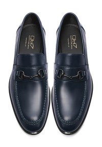 Mocassini in pelle blu navy con punta rotonda, fascia decorativa con hardware in tonalità argento e cuciture blu a contrasto lungo i bordi.