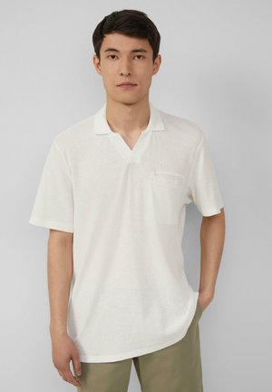 Witte polo met korte mouwen en een v-hals, van gestructureerde stof, met een klein borstzakje. Relaxte pasvorm met rechte zoom.