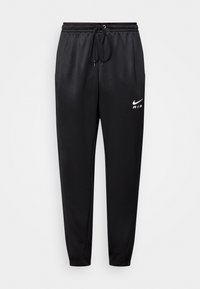 Černé Nike tepláky s elastickým pasem, nastavitelným šňůrkovým uzávěrem, úzkými nohavicemi a bílým logem na levém stehně.