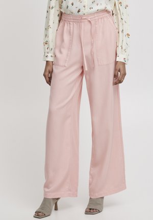 Roze wijde broek gemaakt van zachte stof heeft een elastische tailleband en een trekkoord. Ze hebben twee zijzakken voor functionaliteit.