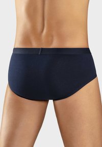 Navy blue cotton briefs with a smooth texture, a wide elastic waistband, and a fitted design, featuring minimal stitching and no patterns.