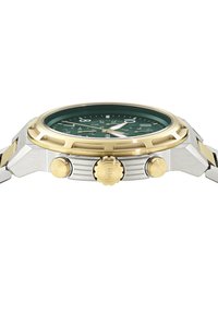 Ceas de mână cu carcasă argintie și aurie, având un cadran verde, marcaje orare proeminente și două coroane. Dispune de o ramă texturată și de o brățară integrată.