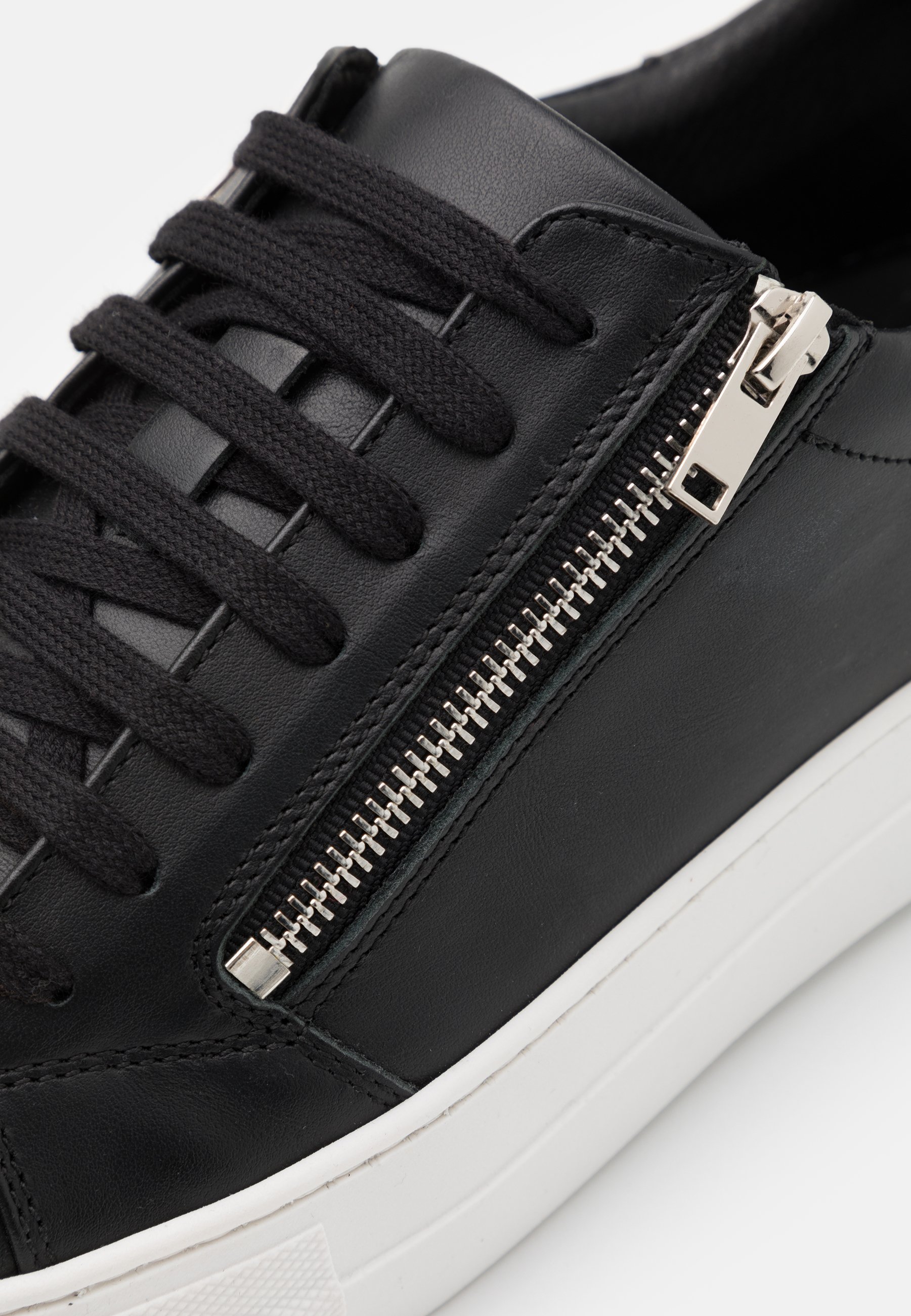 black zip trainers