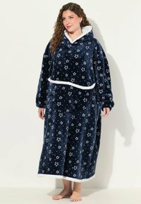 Felpa oversize color blu navy in pile con motivo a stelle, dettagli bianchi, cappuccio foderato in peluche e tasca frontale; maniche lunghe e orlo.