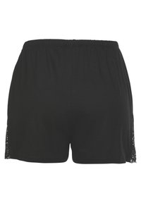 Crne hlačice s elastičnom waistband-om, s čipkastim detaljima sa strane. Meki materijal s glatkom teksturom.