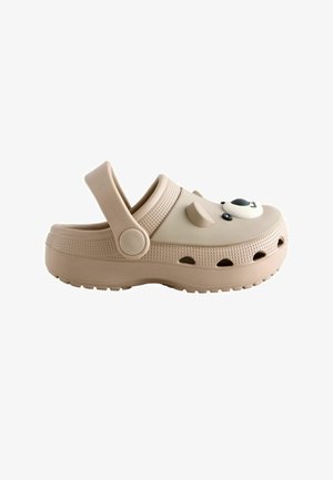 Beige casual clog with ventilation holes, adjustable back strap, and a panda face decoration on the upper front.