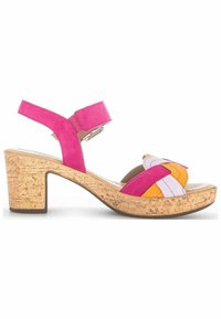 Sandale ouverte à bout ouvert avec bride rose à la cheville, lanières avant tressées multicolores et talon bloc en liège sur fond blanc.