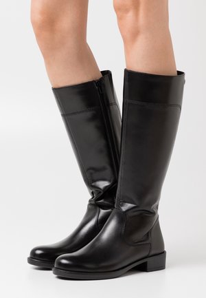 Botas altas hasta la rodilla de cuero negro con punta redondeada y tacón bajo de bloque. Presentan una cremallera lateral y una textura suave y brillante.