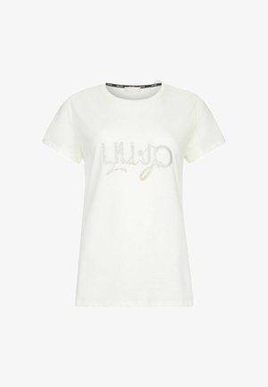 T-shirt en coton blanc à manches courtes. Affiche "Liu Jo" en texte pailleté argent et or sur la poitrine. Col rond avec col de marque.