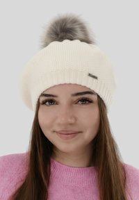 Warm white knitted beret-style hat with a textured pattern and a fluffy gray faux fur pom-pom on top. Features a small metal logo accent.