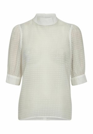 Helle hvite bluse med korte, puffede ermer og høy krage, med et teksturert mønster av små firkanter over hele. Knapplukking bak.