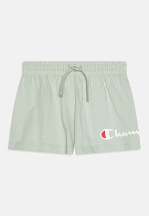 Shorts vert clair à taille élastique avec cordon et logo Champion partiel blanc et rouge sur la partie inférieure de la jambe droite.