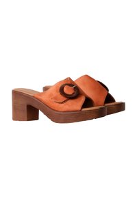 Orange suede block-heeled sandals with an open toe, featuring a decorative circular accent and a wide strap over the foot.