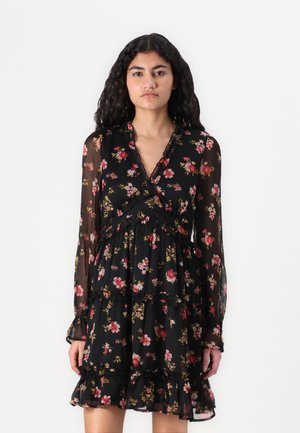 Black floral dress with long sheer sleeves, ruffled accents, and a tiered design featuring pink and yellow flowers against a dark background.