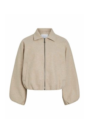 Veste beige zippée avec col, manches ballon longues, deux poches latérales et un ourlet élastique légèrement raccourci.