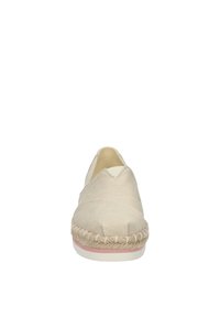 Beige canvas espadrille with a rope sole, almond toe, and a stitched upper design. Features a slight pink accent on the sole.