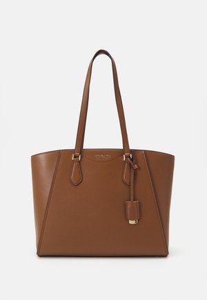 Brown leather tote bag with two shoulder straps, a structured shape, gold-tone hardware, and a decorative tag attached to the front.