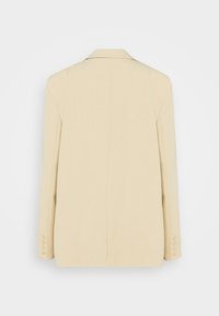 Blazer beige à simple boutonnage avec manches longues et quatre boutons sur chaque poignet, vu de dos sur fond blanc.