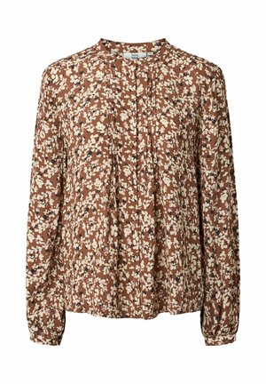 Blouse marron à manches longues avec motif floral blanc et foncé, col rond et petits plis sur le devant.