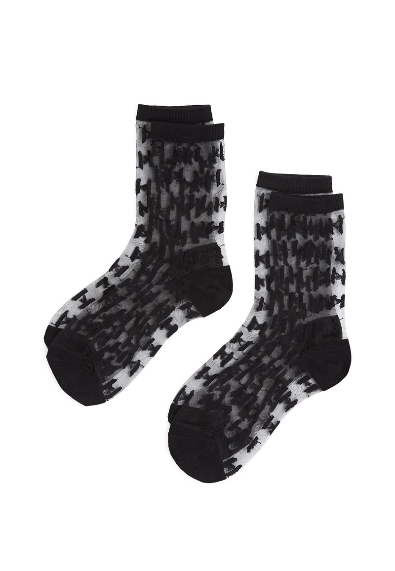 Calcetines de un patrón negro y gris con un acabado semitransparente, que presentan una banda negra en la parte superior y los dedos y talones en negro sólido.