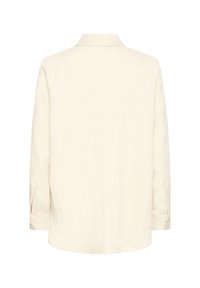 Long-sleeve, cream-colored shirt with buttoned cuffs shown from the back, featuring a classic collar and smooth fabric texture.