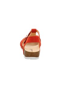 Red suede sandal featuring a closed back, adjustable strap, and light-colored chunky heel with a textured cork surface.
