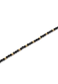 Cuentas negras facetadas alternadas con cuentas doradas redondas, formando una delicada cadena con una textura suave y un diseño simétrico.